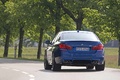 BMW M5 2011 bleu 3/4 arrière gauche