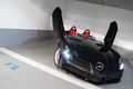 Mercedes McLaren SLR Stirling Moss noir face avant penché portes ouvertes