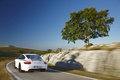 Porsche 997 Carrera GTS blanc 3/4 arrière gauche travelling