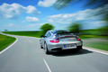Porsche 997 GT2 RS gris 3/4 arrière gauche travelling penché