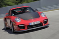 Porsche 997 GT2 RS rouge 3/4 avant droit travelling penché 2