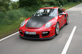 Porsche 997 GT2 RS rouge 3/4 avant gauche travelling 2