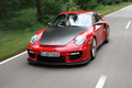 Porsche 997 GT2 RS rouge 3/4 avant gauche travelling