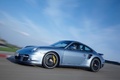 Porsche 997 Turbo S bleu 3/4 avant gauche travelling penché