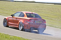 Essai BMW Série 1 M Coupé - orange - 3/4 arrière gauche, drift