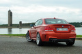 Essai BMW Série 1 M Coupé - orange - 3/4 arrière gauche