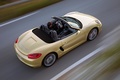 Porsche Boxster - jaune - 3/4 arrière droit supérieur, dynamique